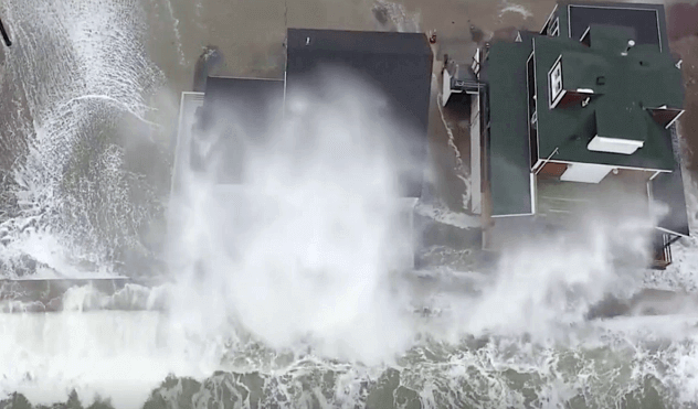 Drone captures behemoth waves lashing coastal homes